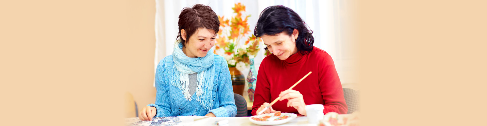 adult woman with special needs are engaged in handcraft in rehabilitation