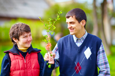 man with disability giving a flower to a woman