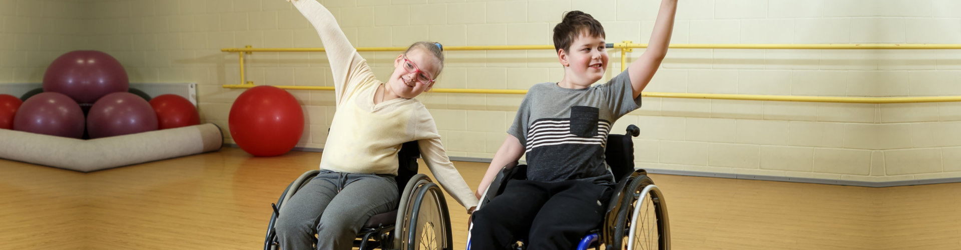 two kids on a wheelchair